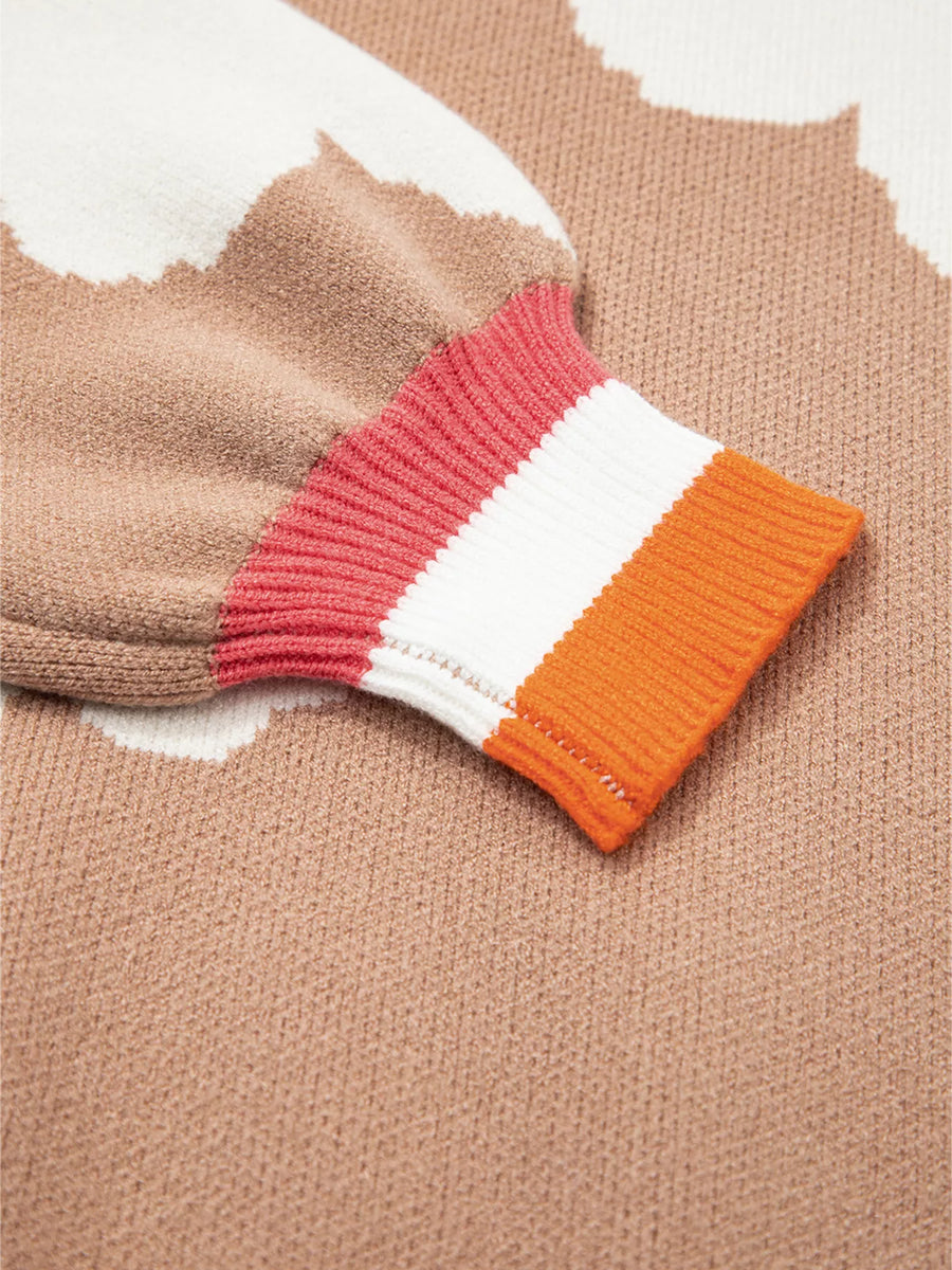 Tan floral pattern sweater with striped ribbed cuffs in coral, white, and orange.