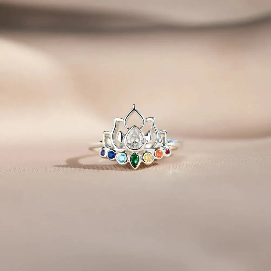 Sterling silver ring with lotus design and colorful chakra gemstones.