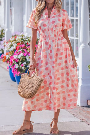 Puff sleeve midi dress in white with pink polka dots, smocked waist, and zip front.