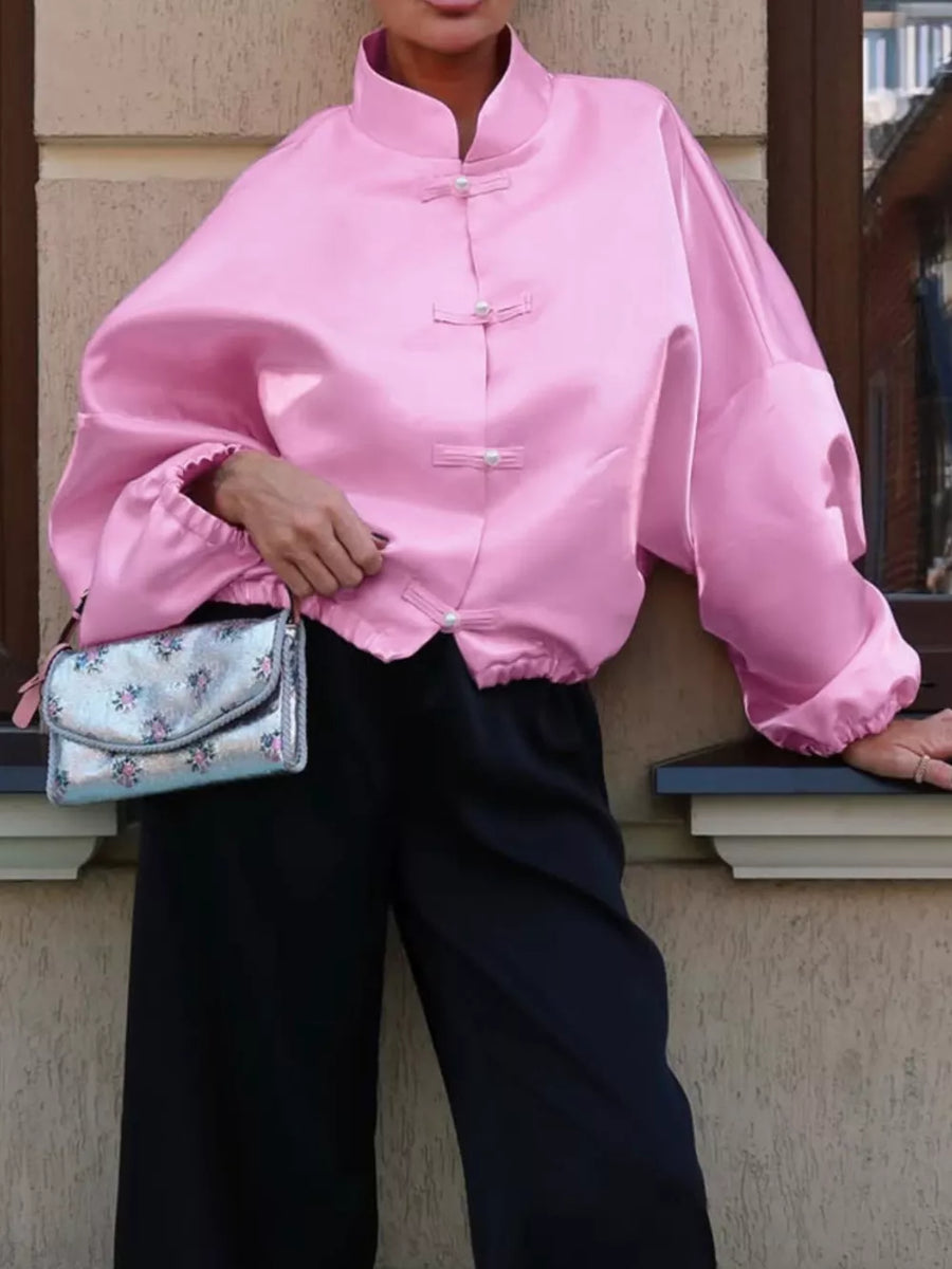 button-up shirt in pink featuring buttoned and oversized fit