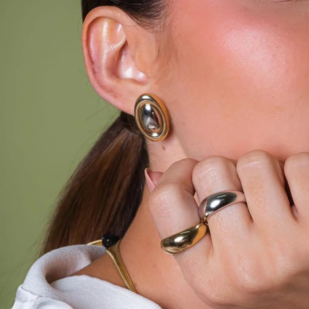 Gold two-tone oval statement earrings with a bold, polished finish.