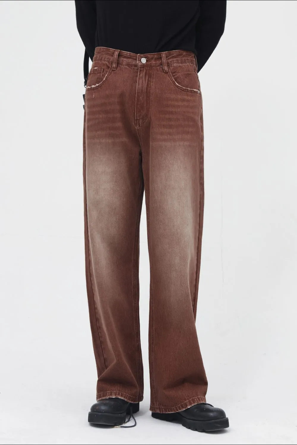 Brown faded wash wide leg denim trousers with distressed details.