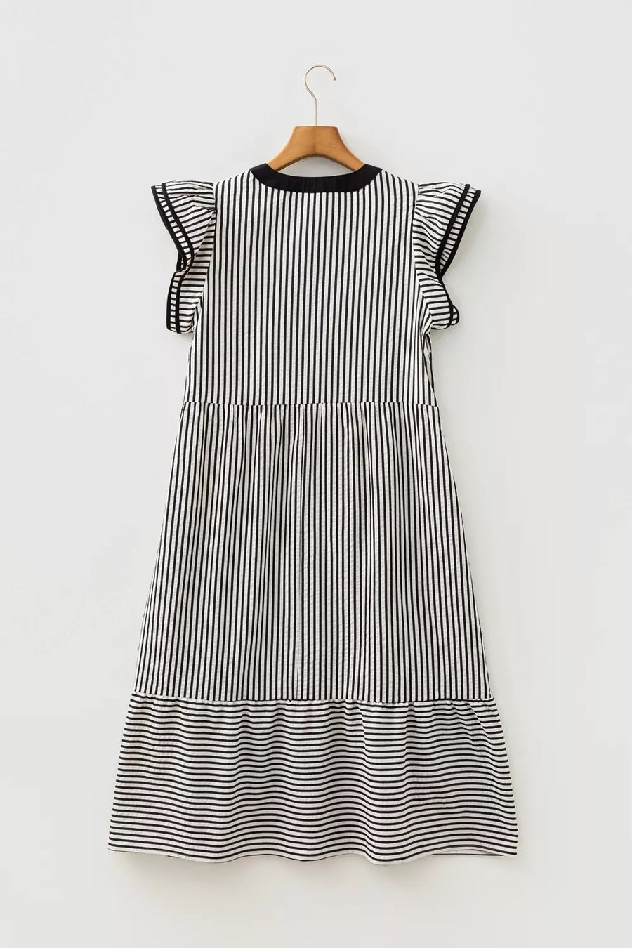 Black and white striped tiered midi dress with ruffle sleeves and pockets.