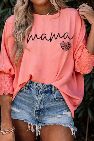 Coral mama heart print blouse with blouson sleeves and smocked cuffs.