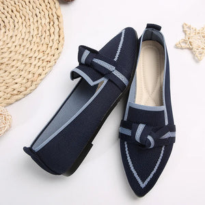 Dark blue knit bow loafers with contrast trim and pointed toe.