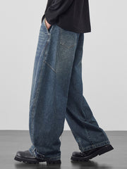 Men's baggy vintage wash jeans in dark blue denim with cinched hems.