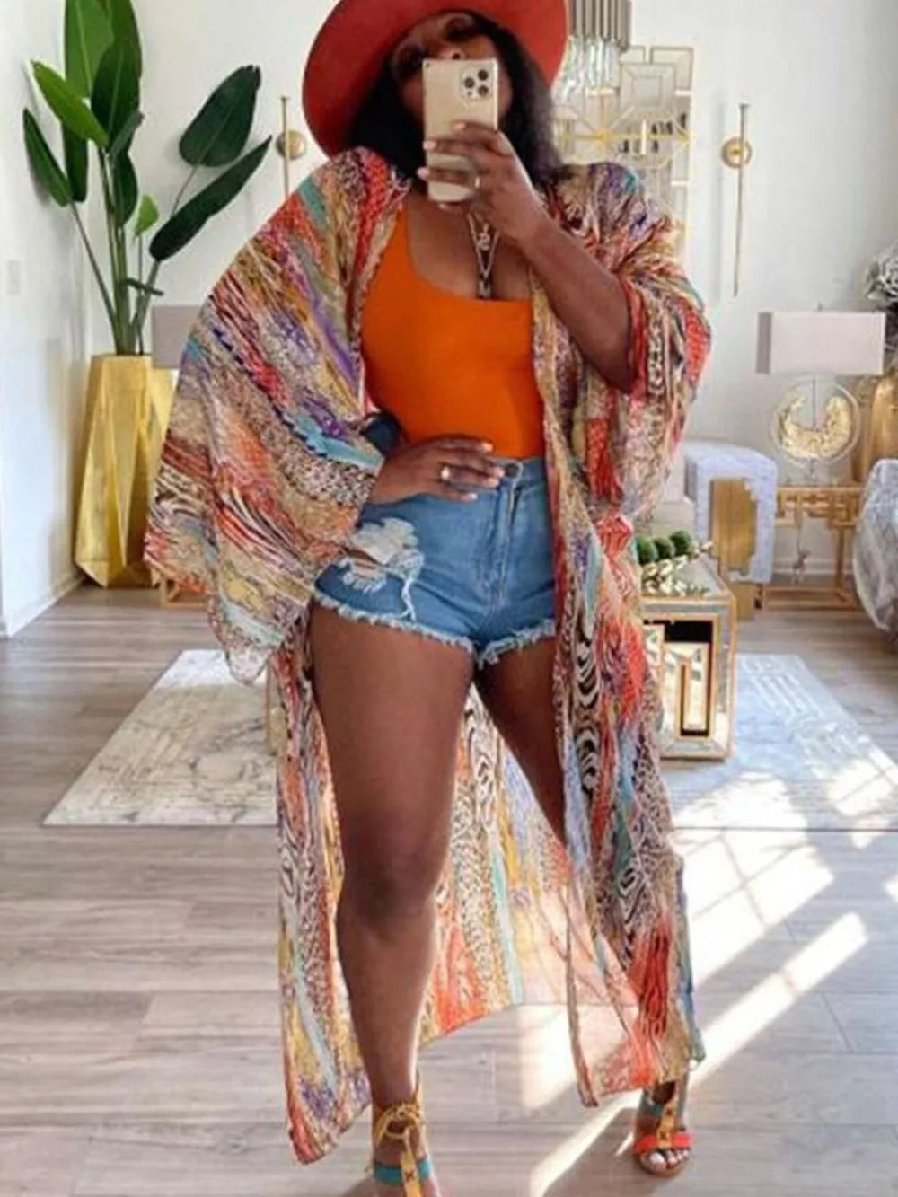 Vibrant bohemian print open-front long cardigan with wide sleeves and abstract patterns.