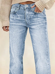 Light blue denim straight leg jeans with vintage wash and button fly.