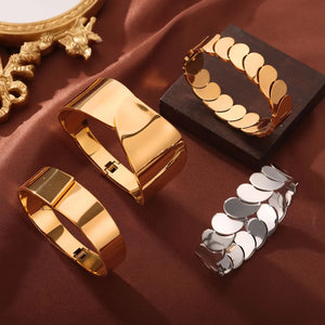 Gold leaf bracelets, one cuff style, one with petal links, and one silver petal link bracelet.