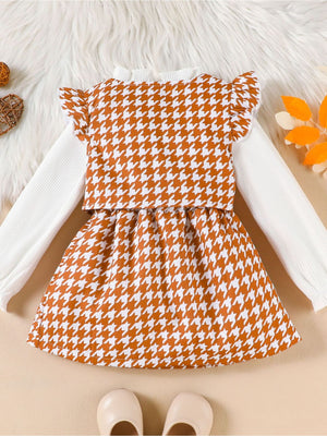 Toddler houndstooth vest and skirt set with white ribbed long sleeve shirt and ruffled sleeves.