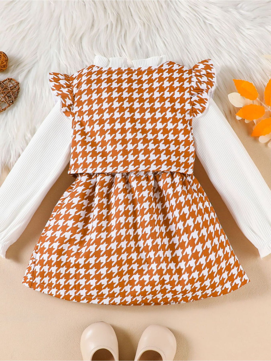 Toddler houndstooth vest and skirt set with white ribbed long sleeve shirt and ruffled sleeves.