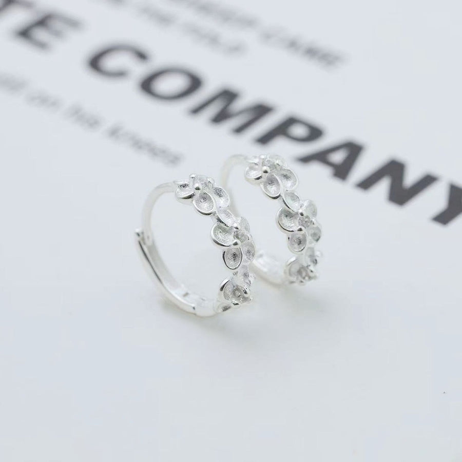 Silver earrings featuring floral embellishment and floral