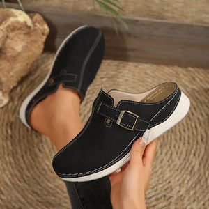 Black slip-on flats with buckle accent and contrast stitching