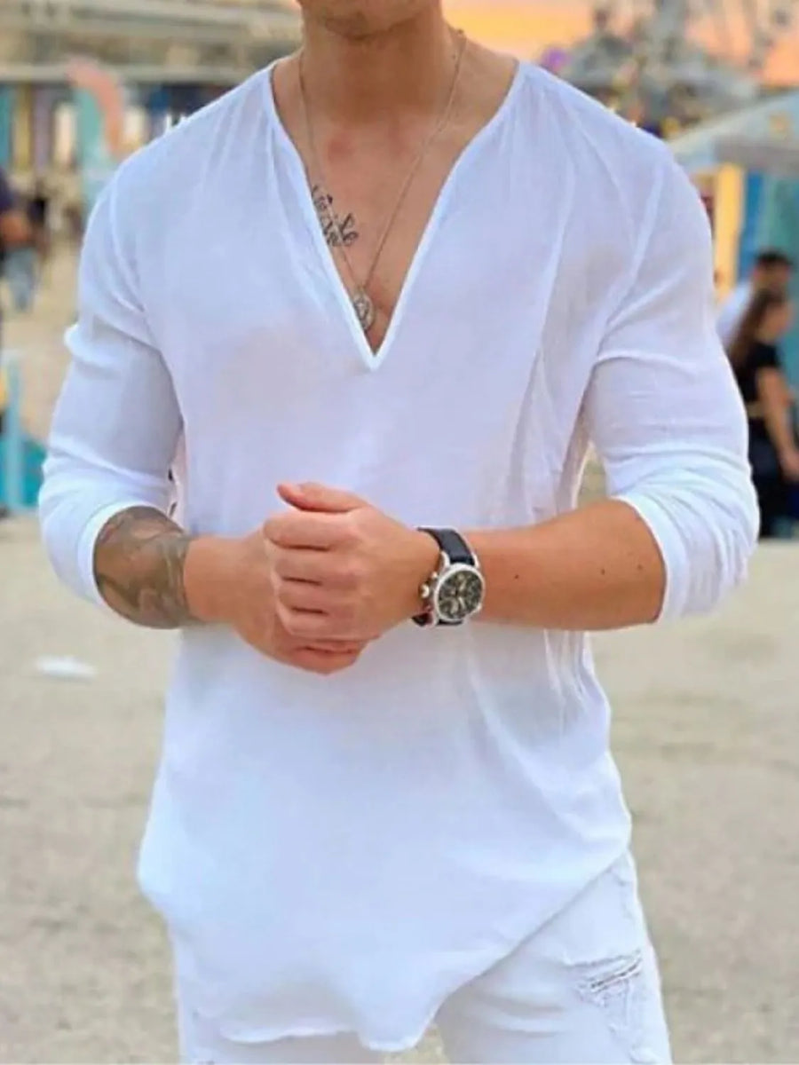 White linen relaxed fit top with deep V-neck and long sleeves.