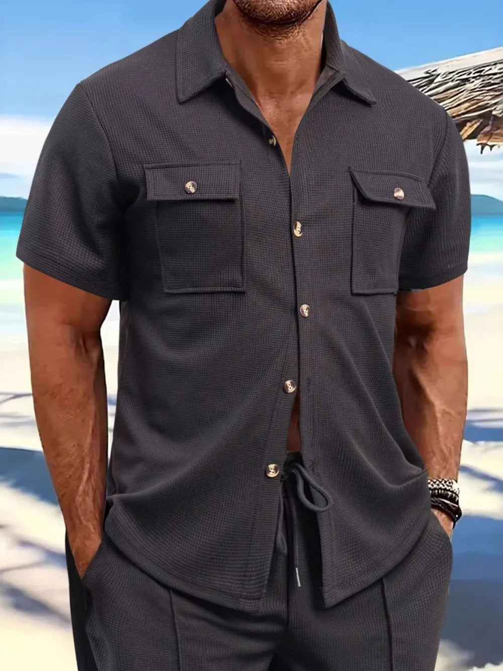 Textured gray resort shirt with buttoned patch pockets and short sleeves.