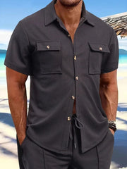 Textured gray resort shirt with buttoned patch pockets and short sleeves.