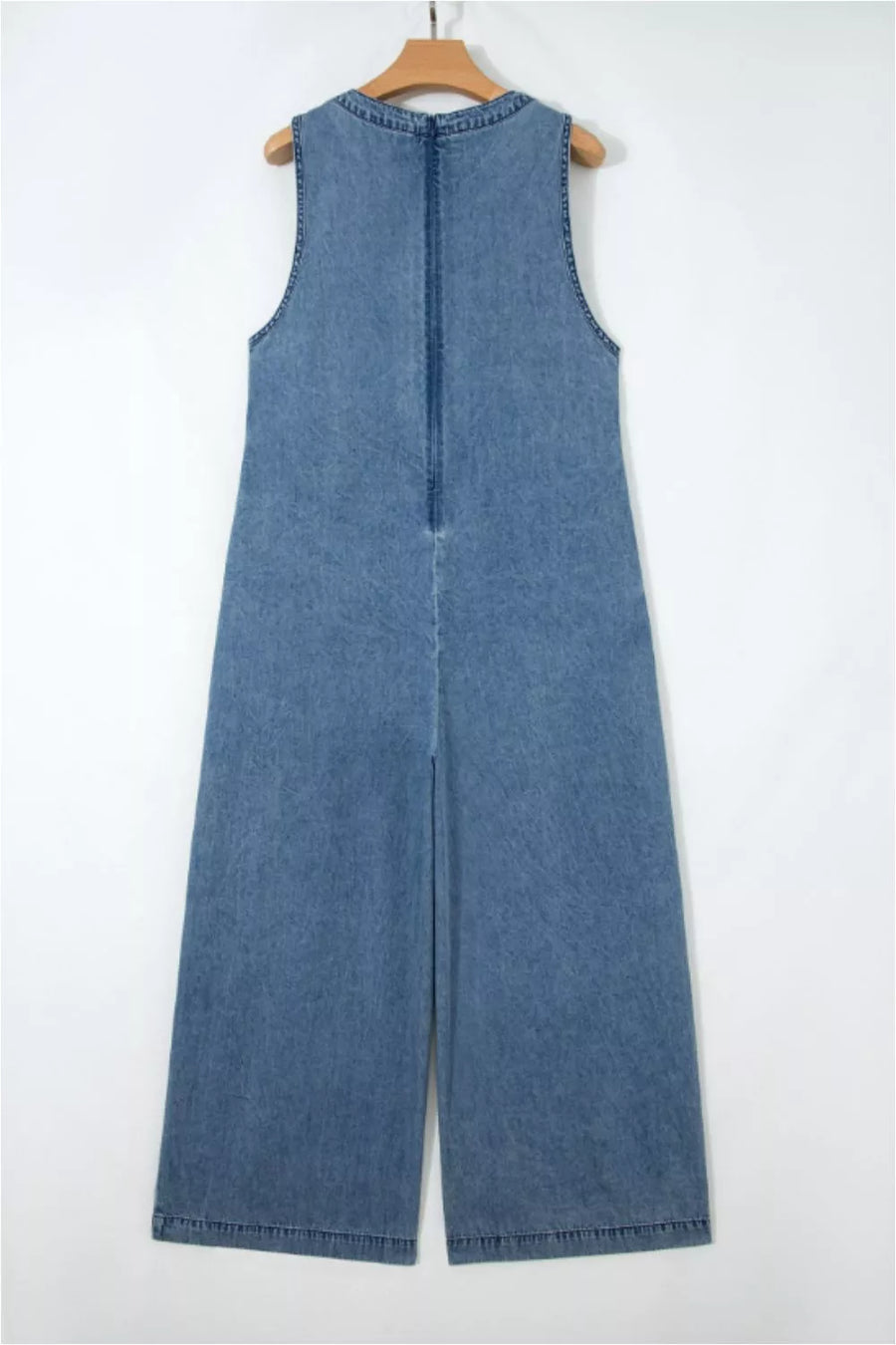 Denim jumpsuit with V-neck, sleeveless, wide leg, and back zipper detail.