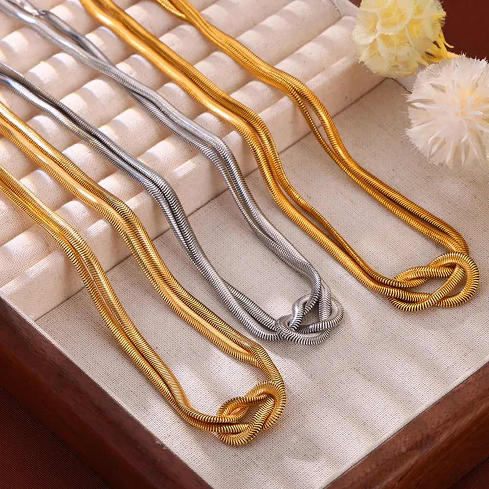 Gold and silver snake chain necklaces with knot detail