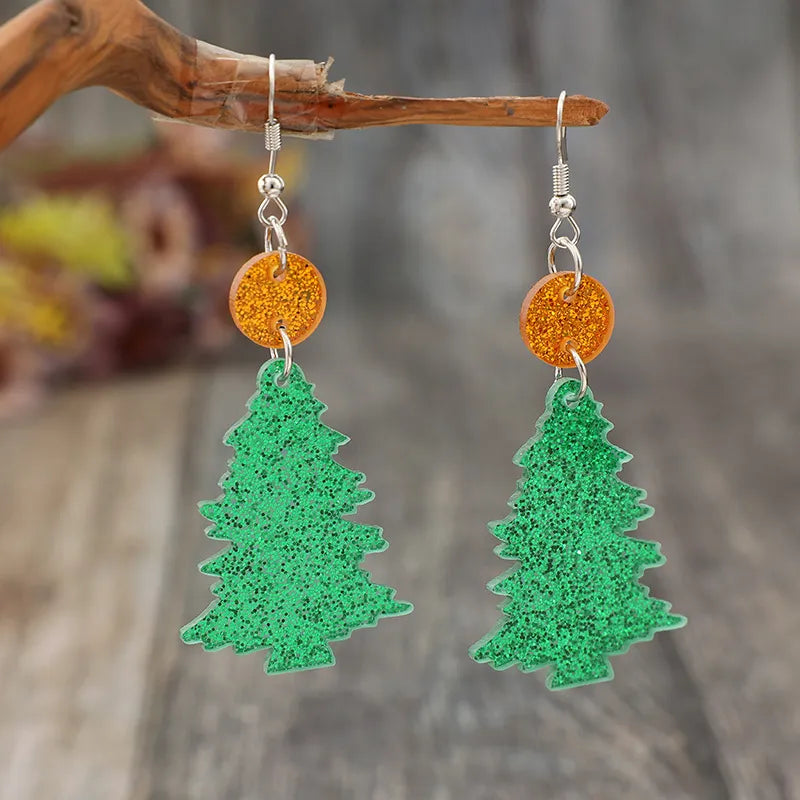 Glittering green acrylic Christmas tree drop earrings with orange glitter circles.