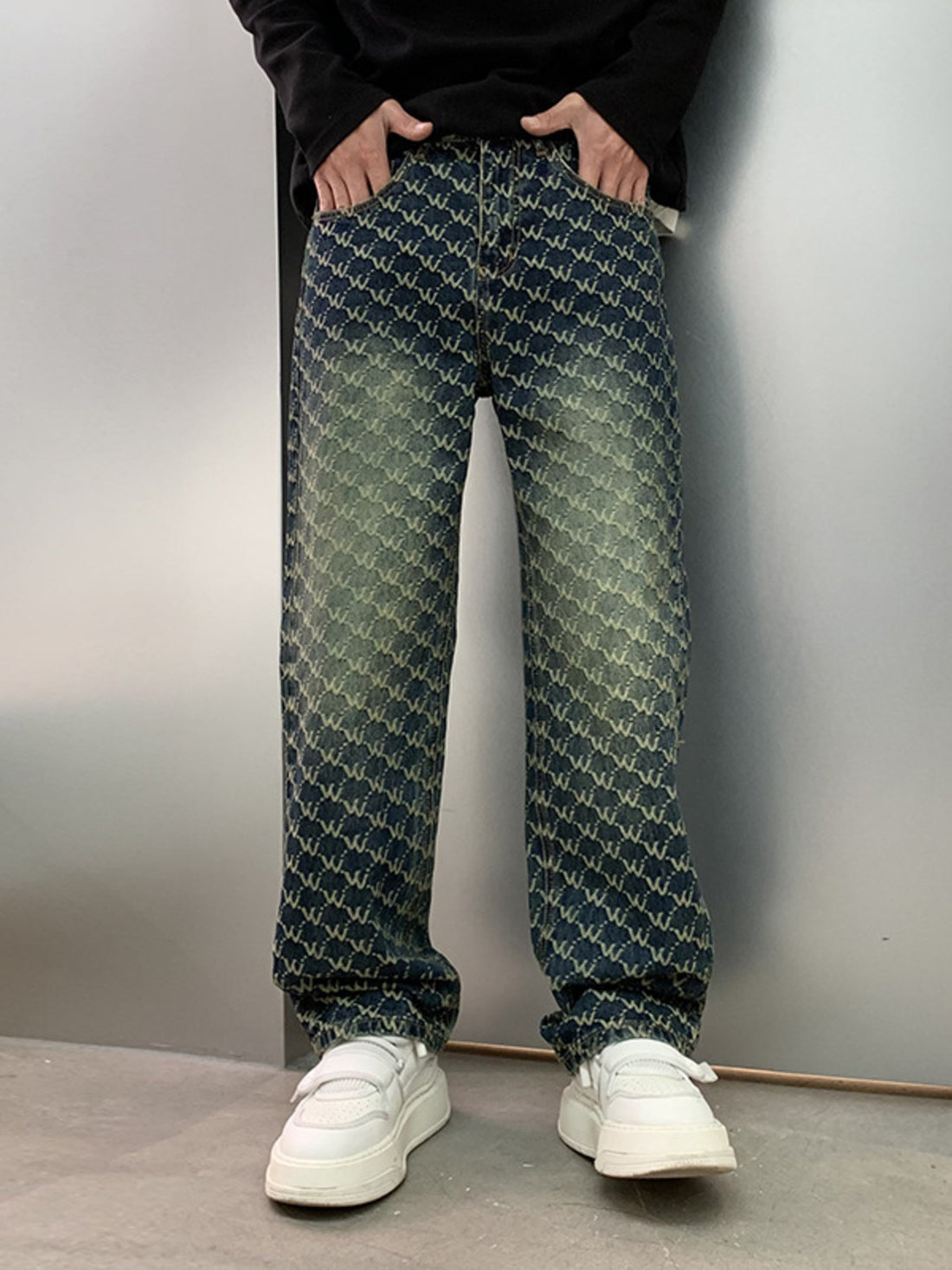 Men's relaxed fit jeans in dark wash denim with all-over woven motif pattern and distressed details.
