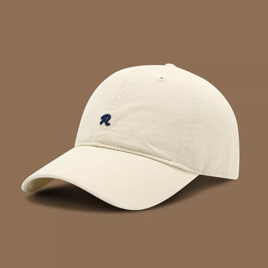 Cream baseball cap with embroidered navy R logo