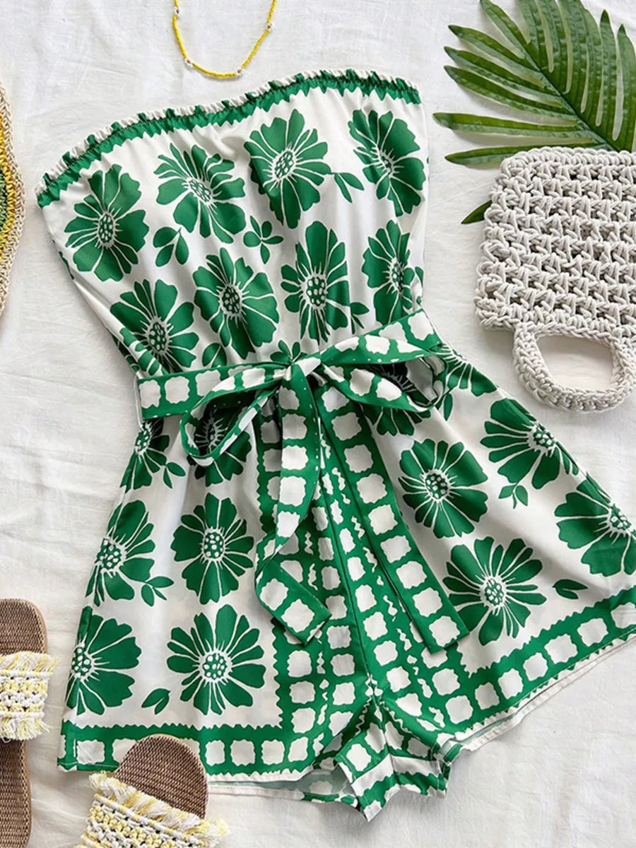Green floral tie-waist strapless maternity romper with ruffled hem and square print trim.