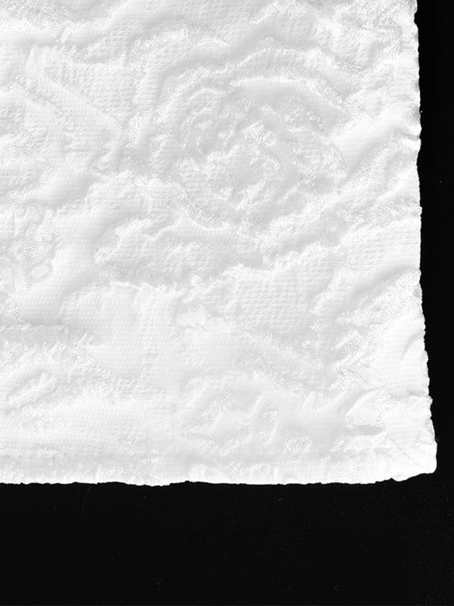 Textured white mini dress fabric with a raised floral pattern