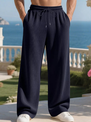 Navy blue ribbed drawstring sweatpants with relaxed fit and wide leg.
