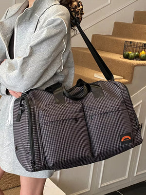 Chic medium plaid duffel bag with multiple exterior pockets and a leopard print strap detail.
