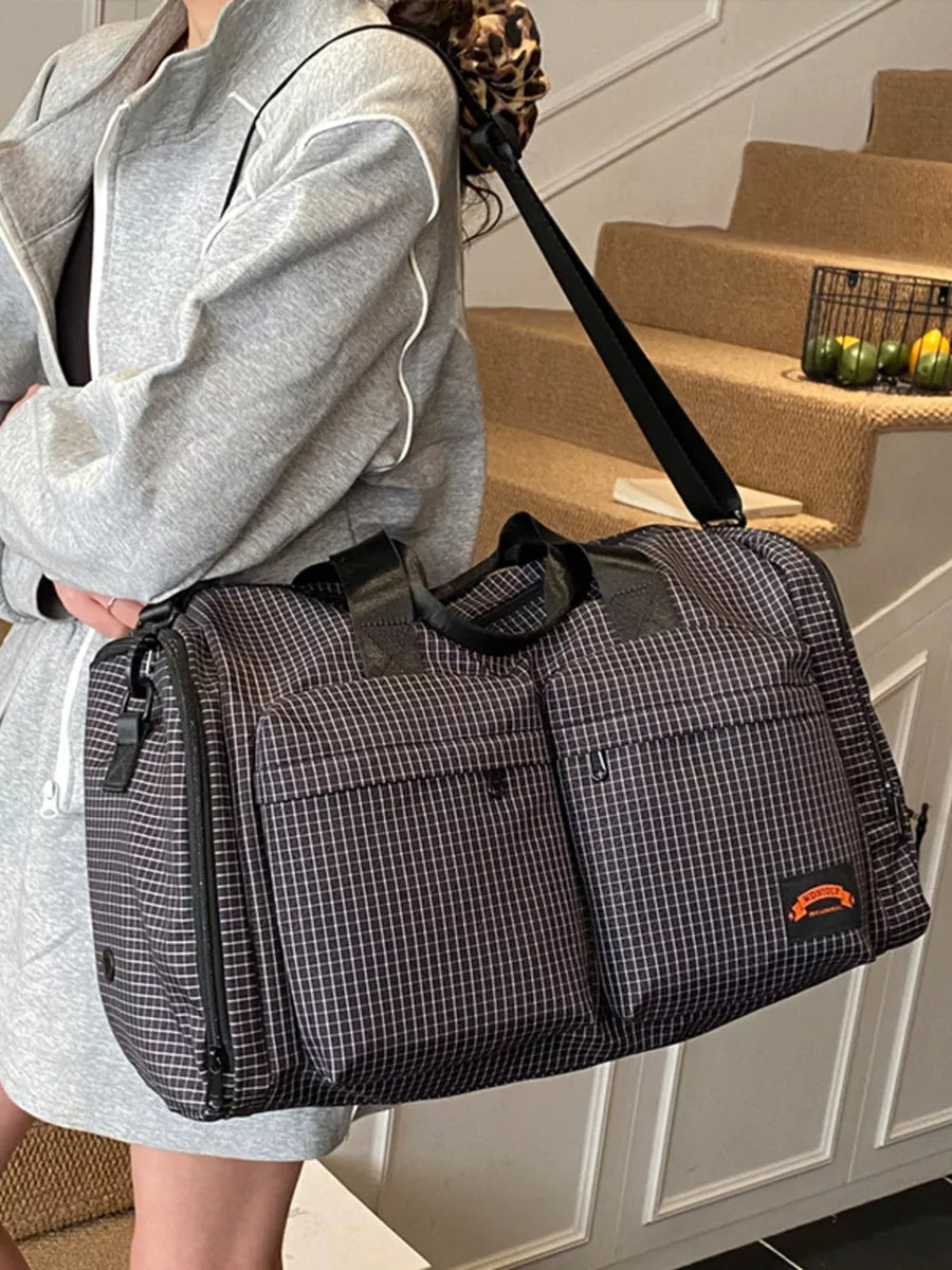Chic medium plaid duffel bag with multiple exterior pockets and a leopard print strap detail.