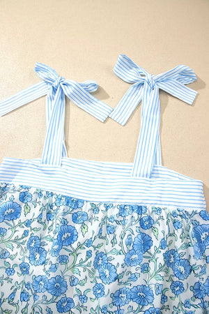 Blue floral print cami top with adjustable tie straps and striped trim, part of a loungewear set.