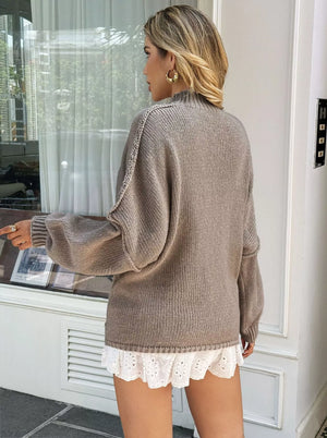Mock neck oversized sweater in khaki with drop shoulders and textured sleeves.