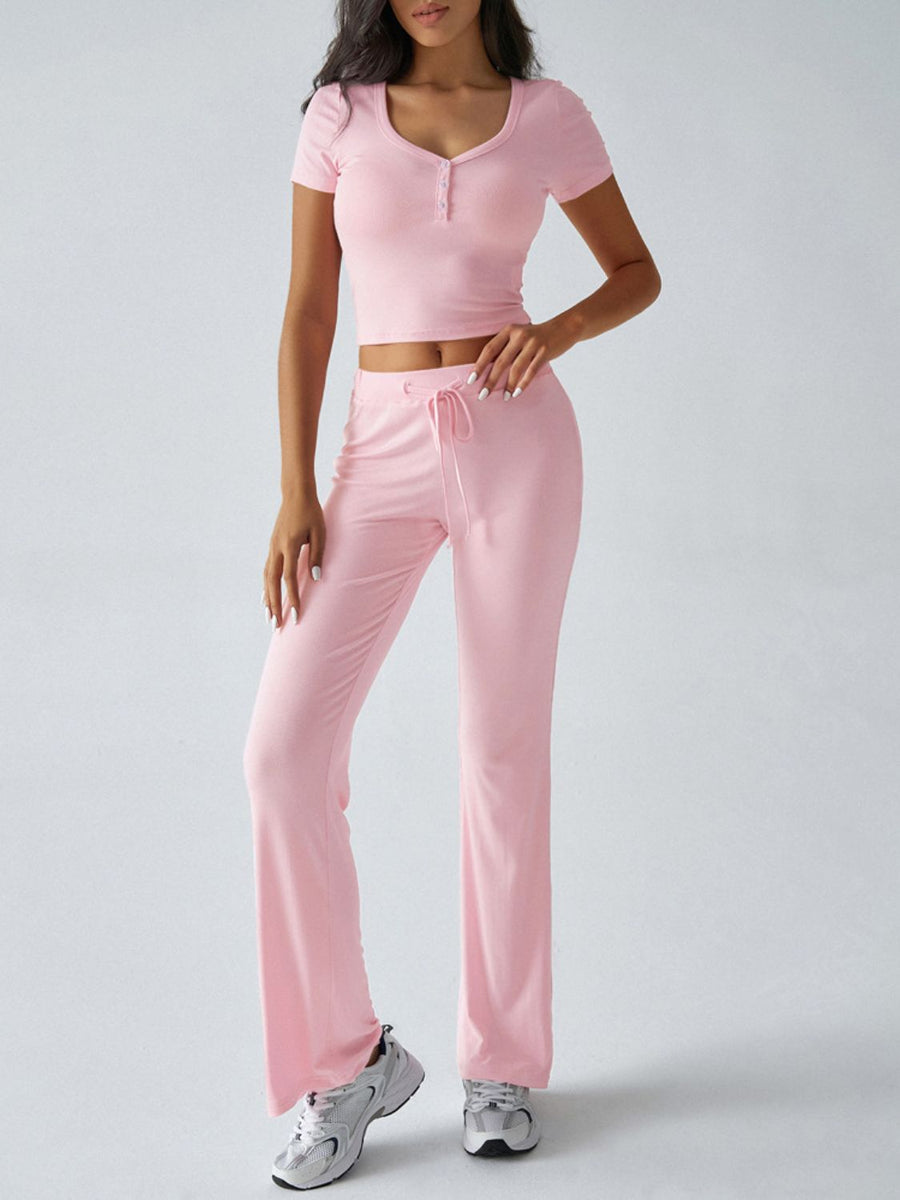 Blush pink button-front crop top and flared lounge pants with drawstring waist.