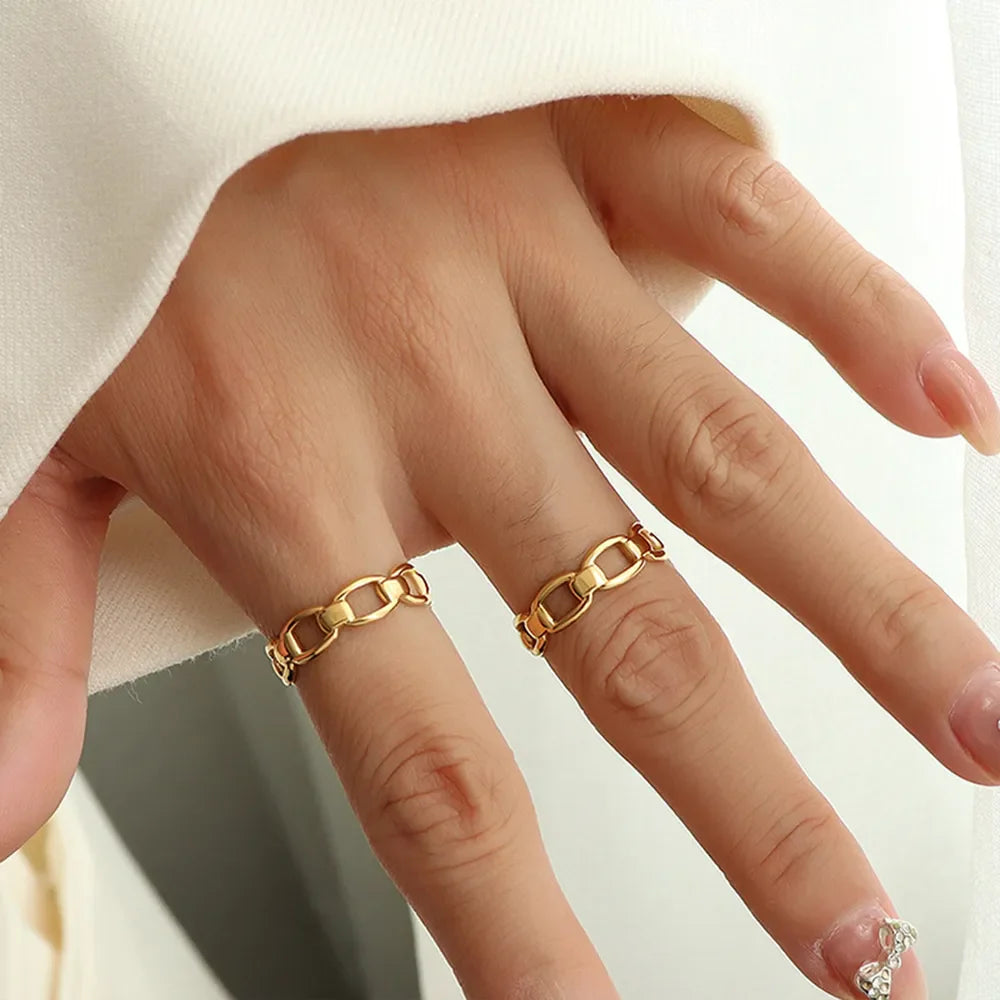 Gold chain link adjustable ring on a woman's finger