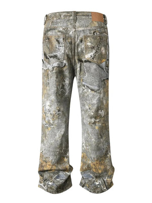 Distressed treasure print wide leg jeans in gray denim with distressed details and pocket embellishments.