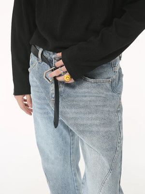 Flared denim jeans in medium wash with sculpted seam detail and a black belt.