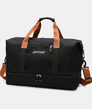 Black dual-compartment weekender bag with contrast brown straps and a zippered bottom compartment.