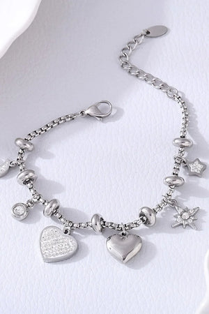 Silver charm bracelet with hearts, stars, and cubic zirconia accents.