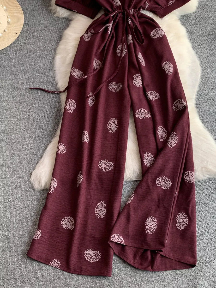 Burgundy maternity joggers with white paisley print and drawstring waist.