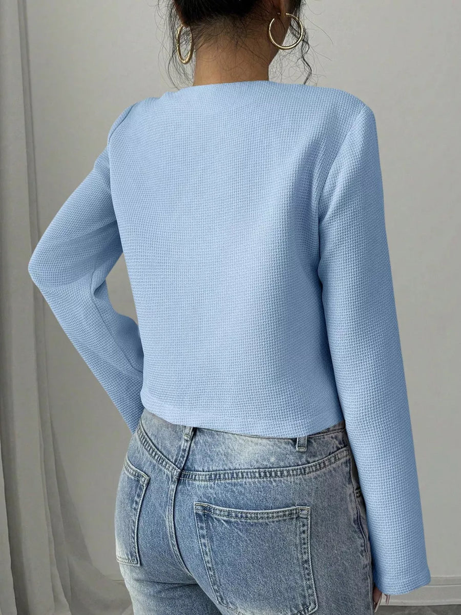Light blue textured long sleeve top with crew neck