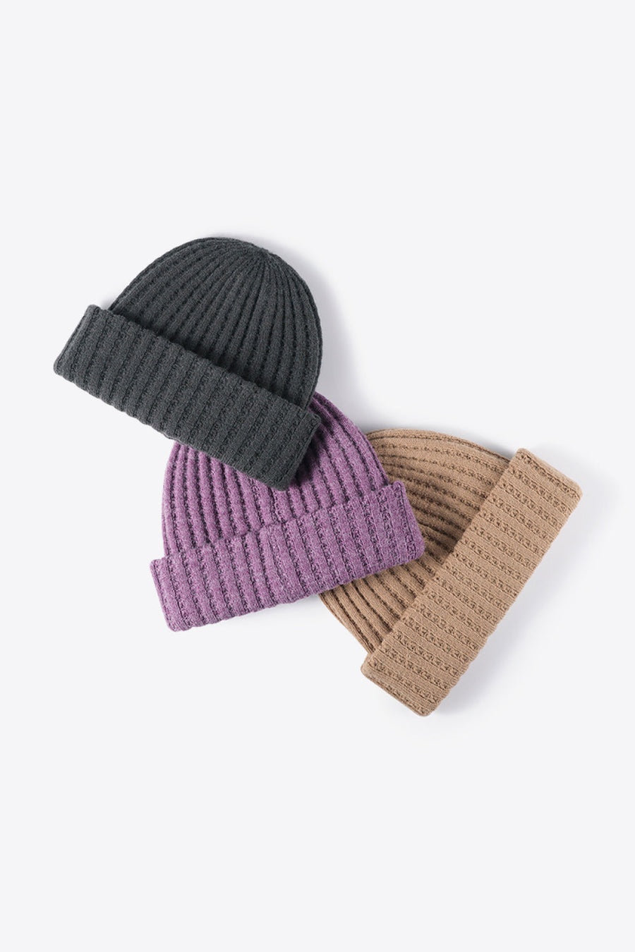 Textured ribbed knit beanies in dark gray, purple, and khaki acrylic.