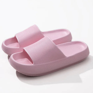 Pink textured cloud slides slippers with thick soles and airy design.