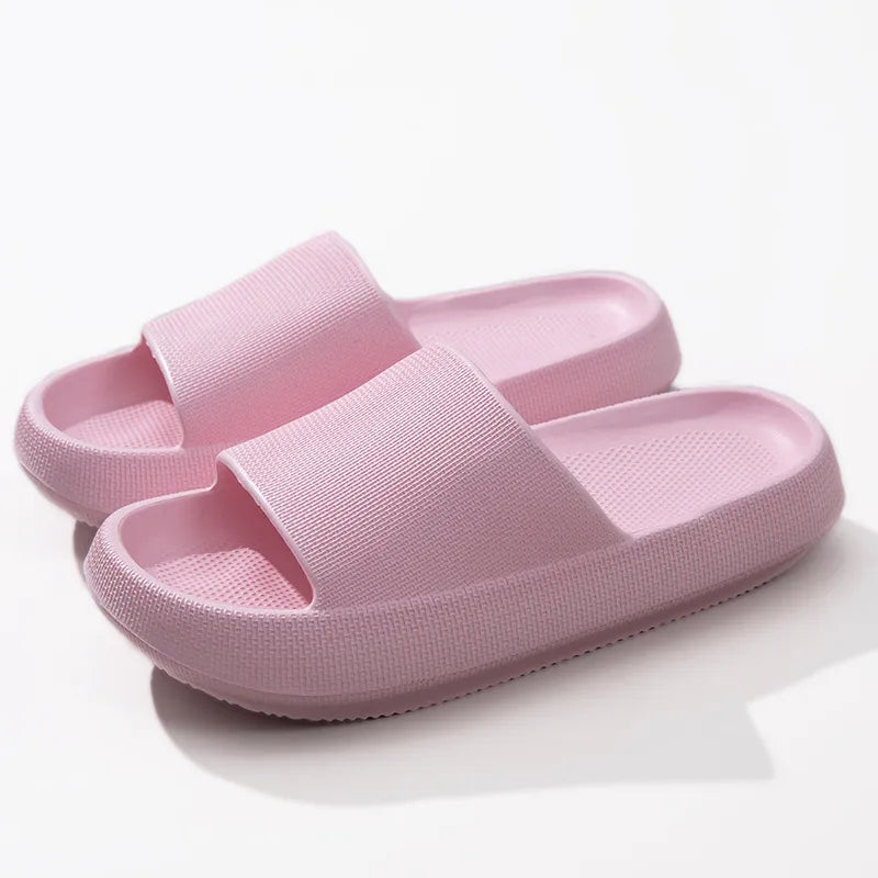 Pink textured cloud slides slippers with thick soles and airy design.