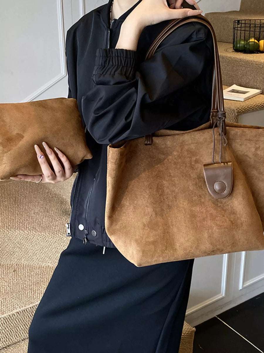 Large caramel brown suede tote bag with matching clutch and leather trim.