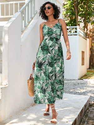 Chic floral midi dress with spaghetti straps in dark green, featuring a tropical leaf print and V-neck.