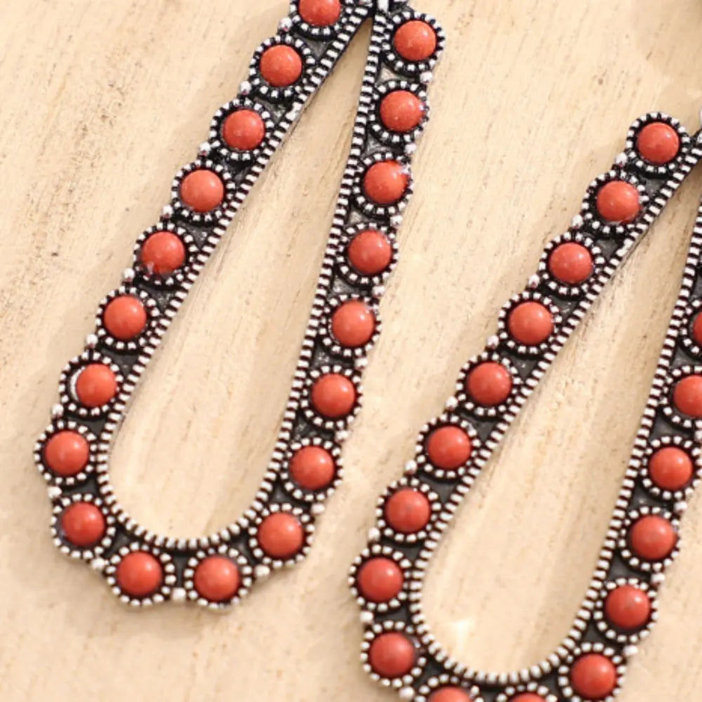 Coral bead teardrop earrings with silver-tone alloy setting.