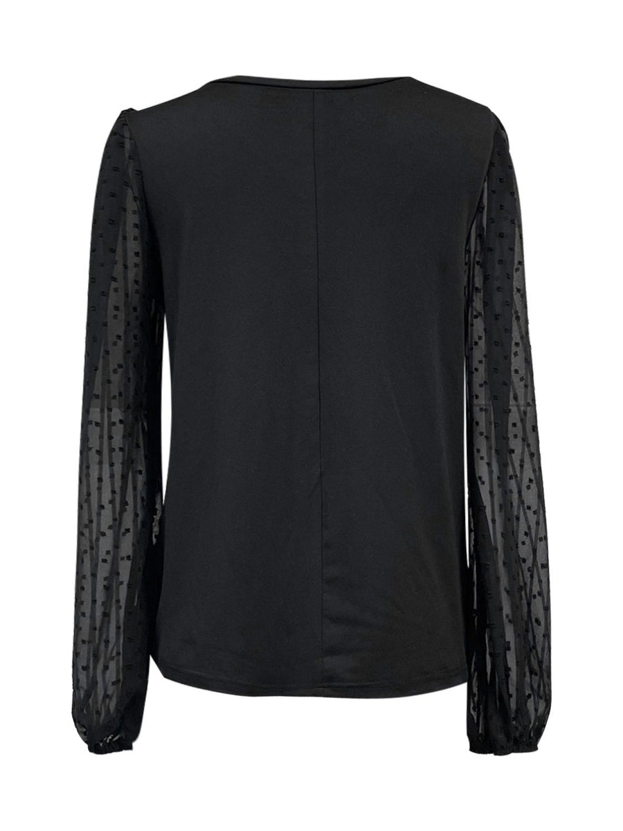 Black blouse with sheer dot long sleeves and V-neck.