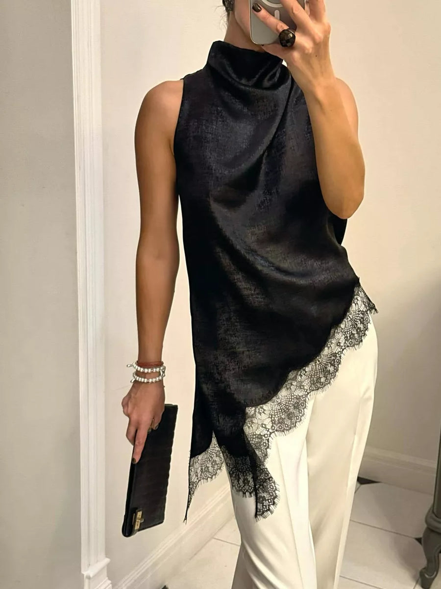 Black asymmetrical cami top with lace trim and draped neckline.
