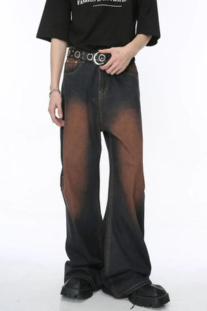 Acid wash flare jeans in dark denim with a gradient brown pattern and silver stud detailing.