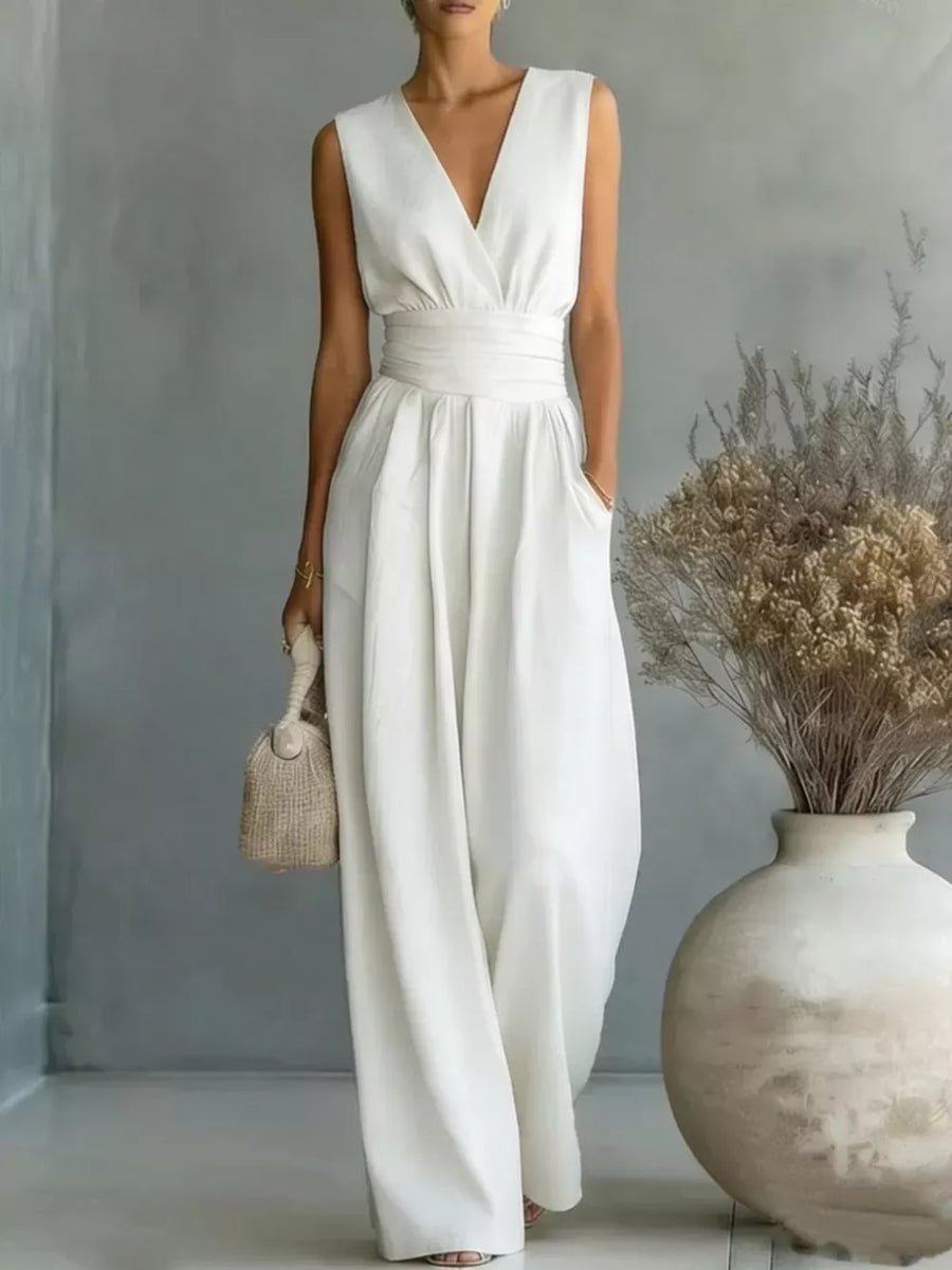 White sleeveless wide-leg jumpsuit with V-neck, cinched waist, and pockets.